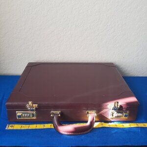 Burgundy leather attaché briefcase with a three-digit combination lock and gold-